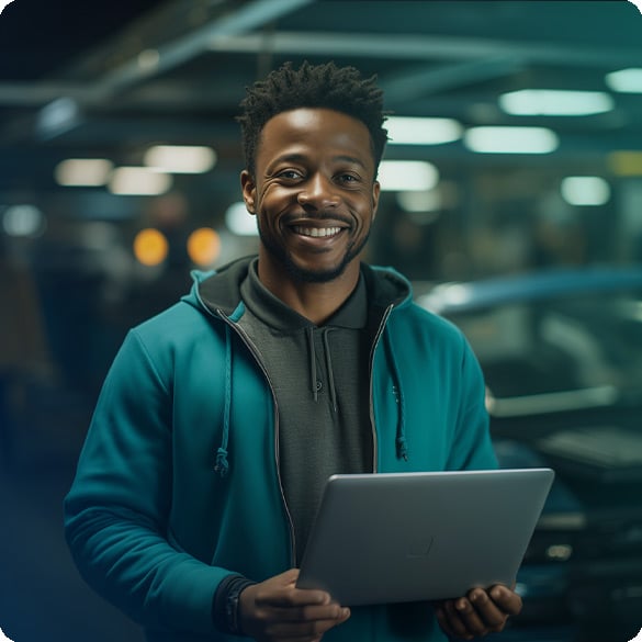 121_African-american-auto-mechanic-holding-laptop_585x585